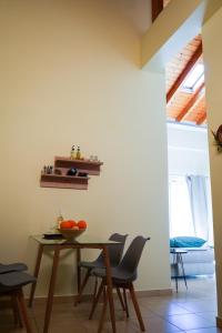 a dining room with a table and chairs at Aggeliki's guest house in Nafplio
