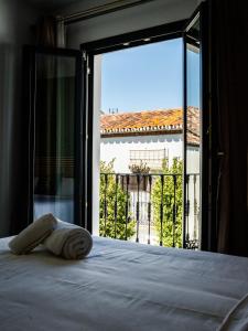 a bed in a room with a large window at Ancha Village in Marbella