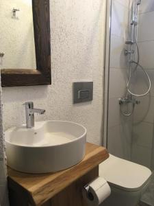 a bathroom with a sink and a toilet and a mirror at By Muhtar Hotel Bodrum in Bodrum City +37 photos