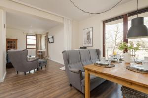 a dining room with a table and chairs at City Center Apartment with Balcony by Renters in Gdańsk