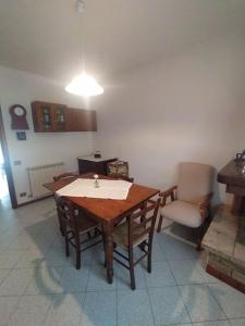 a dining room with a table and a chair at Casa Paola in Cetona +11 photos