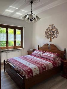a bedroom with a bed and a chandelier at La Casa Di Sabi in Locana