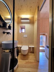 a bathroom with a white toilet and a sink at Casas do Talasnal in Lousã +38 photos