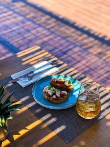 a table with a blue plate with food on it at SECRET HILL in Athani