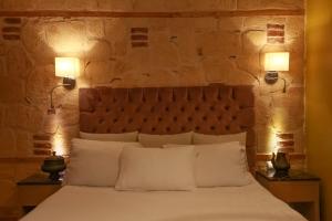 a bedroom with a large bed with two lamps at Swim-Up Garden Flat with near Hadrian's Gate in Antalya