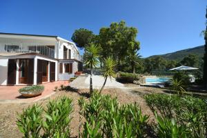 a house with a swimming pool in front of it at Villa EnriMar in Capoliveri