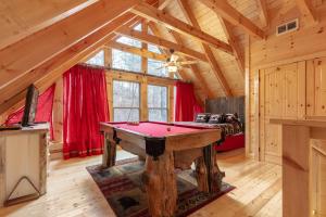 a room with a pool table in a cabin at Simply Unforgettable in Gatlinburg