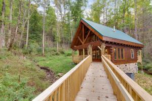 a log cabin in the woods with a wooden bridge at Simply Unforgettable, 1 Bedroom, Pool Table, Arcade, Hot Tub, Sleeps 6 in Gatlinburg