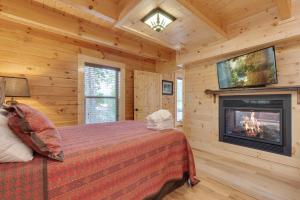 a bedroom with a bed with a fireplace and a tv at Simply Unforgettable, 1 Bedroom, Pool Table, Arcade, Hot Tub, Sleeps 6 in Gatlinburg