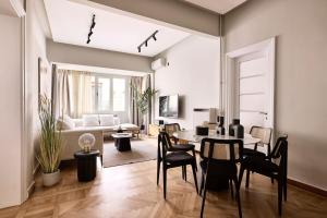 een woonkamer met een tafel en stoelen bij The New, Athens Center by Aura Homes in Athene
