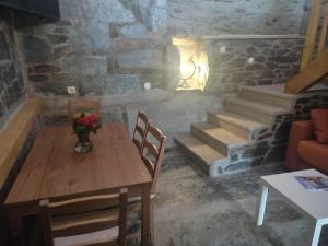 a dining room with a table and chairs and stairs at Petite Vista Douro in Valença do Douro
