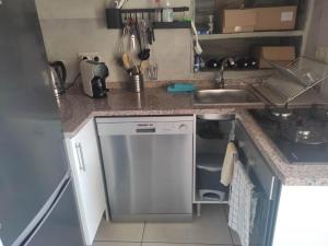 a small kitchen with a dishwasher and a sink at Petite Vista Douro in Valença do Douro