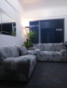 a living room with a couch and a couch and a chair at Ambassador Guest House Bed and Breakfast in Paignton