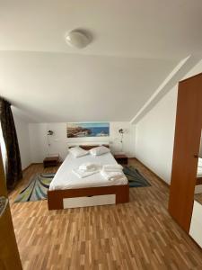 a bedroom with a bed in a room at Casuta Morena in Tuzla