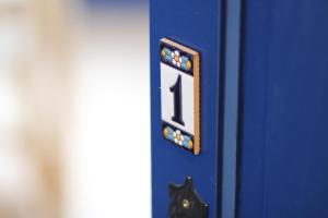 a blue door with a number one sign on it at Apartament - COMPARTIR in Cadaqués