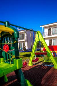 a playground with a green swing set in a yard at complex turistic N&S in 2 Mai