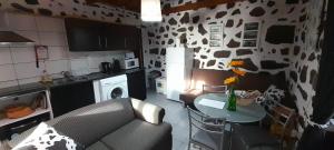 a kitchen with a couch and a table in a kitchen at AL - Adega do Terra in Madalena