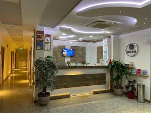 a lobby of a hospital with a reception counter at Hotel Santana in Altınoluk