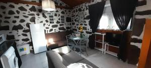 a living room with a cow print wall at AL - Adega do Terra in Madalena