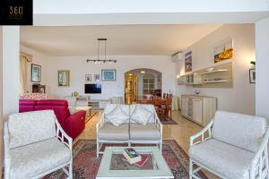 a living room with two chairs and a couch at Tower Road Sliema, 4BR APT with sensational views by 360 Estates in Sliema
