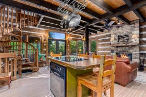 cocina con mesa, sillas y chimenea en Little Bear, en Gatlinburg