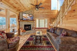 a living room with a couch and a fireplace at Rocky Top Lookout, 4 BR, Theater, Arcade, Bumper Pool, Hot Tub, Sleeps 12 in Gatlinburg