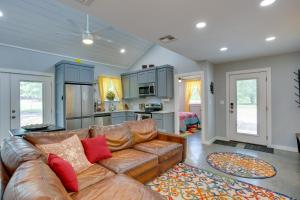 a living room with a brown couch and a kitchen at Quiet Mount Vernon Escape Fish, Hike and Unwind! in Mount Vernon