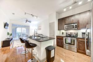 a large kitchen with wooden cabinets and a counter top at Resort-style Pool, Gym/Garage, 1Br, Medical Center in Houston