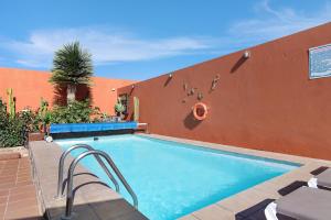 a swimming pool in front of a wall with at La Casita de Vals in Valsequillo