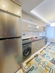 a kitchen with a stainless steel refrigerator and a washer at Super value in Istanbul