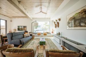 a living room with a couch and a table at B.Hostel in Comporta