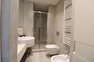 a bathroom with a sink and a toilet and a shower at Elegant and Luxury Apartment @Altare della Patria in Rome