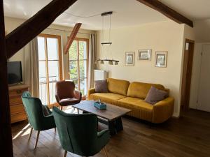 a living room with a couch and a table at Ferienhaus Ausonius in Neumagen-Dhron