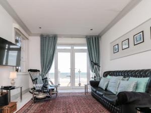 a living room with a couch and a large window at Crystal Cove in Bridlington