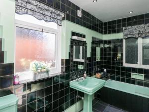 a bathroom with a sink and a tub and a window at Crystal Cove in Bridlington +23 photos