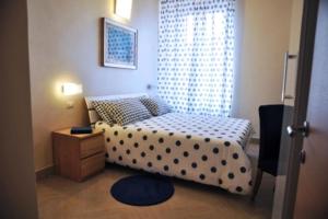 a bedroom with a bed with a polka dot bedspread at Bed & Breakfast Agli Horti Sallustiani in Rome