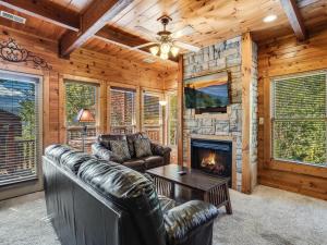 a living room with a couch and a fireplace at Heaven's View, 2 Bedrooms, Sleeps 10, Hot Tub, Pool Table, Arcade, Jacuzzi in Gatlinburg