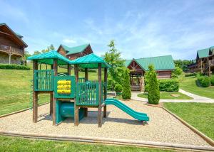 a playground with a slide in a yard at A Mountain Paradise in Pigeon Forge