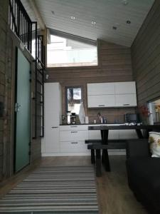 a kitchen with a sink and a counter top at Luxury guesthouse, beachfront sauna in Jyväskylä