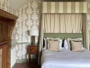 a bedroom with a bed with pillows on it at The Barnsdale, Rutland in Oakham