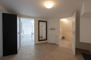an empty hallway with a mirror and a door at Top Wenceslas Square Apartment in Prague +132 photos