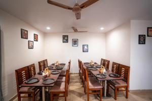 a dining room with a long table and chairs at Yellow Bells Signature HITEC City in Hyderabad