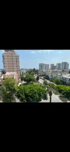 a view of a city with trees and buildings at Elit semtte muhteşem konumda daire in Antalya