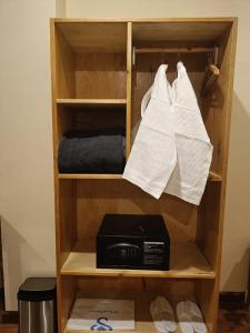 a book shelf with a box and towels at Shomo Chuki Resort in Paro