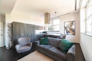 a living room with a couch and a chair at Milan Design Suite - Palestra e Parcheggio Privato in Milan