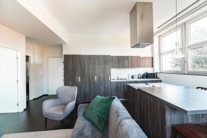 a living room with a couch and a kitchen at Milan Design Suite - Palestra e Parcheggio Privato in Milan +18 photos