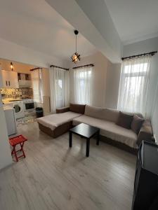 a living room with a couch and a table at Centeral Apartment in Kaş