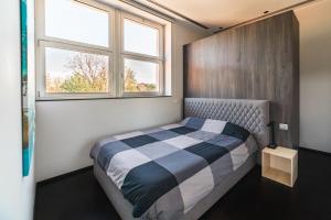 a small bedroom with a bed and a window at Milan Design Suite - Palestra e Parcheggio Privato in Milan