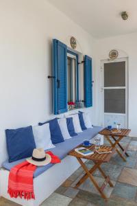 a living room with a blue couch and a table at Summer House - Finikas Syros in Víssa