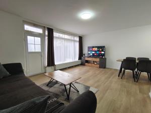 a living room with a couch and a table at City House - up to 8 Persons in Kapfenberg